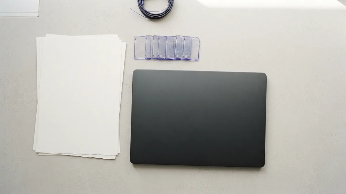 Blank paper and laptop arranged to represent JSON and XML data formats