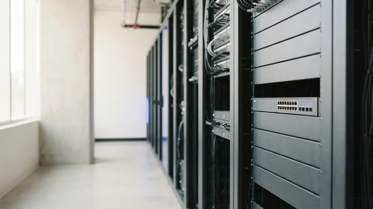 Bright server aisle with network hardware showing a controlled software testing environment