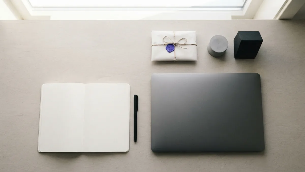Blank notebook, laptop, parcel, and product samples arranged for ecommerce market research